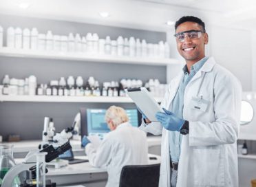 Science, tablet and portrait of a male scientist doing research with technology in an ecology laboratory. Happy, smile and man botanist working or researching on a mobile device in a botanical lab.