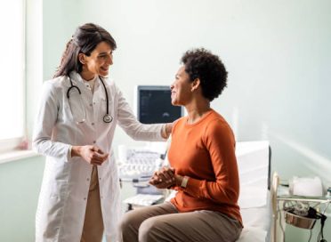 Female medical practitioner reassuring a patient
